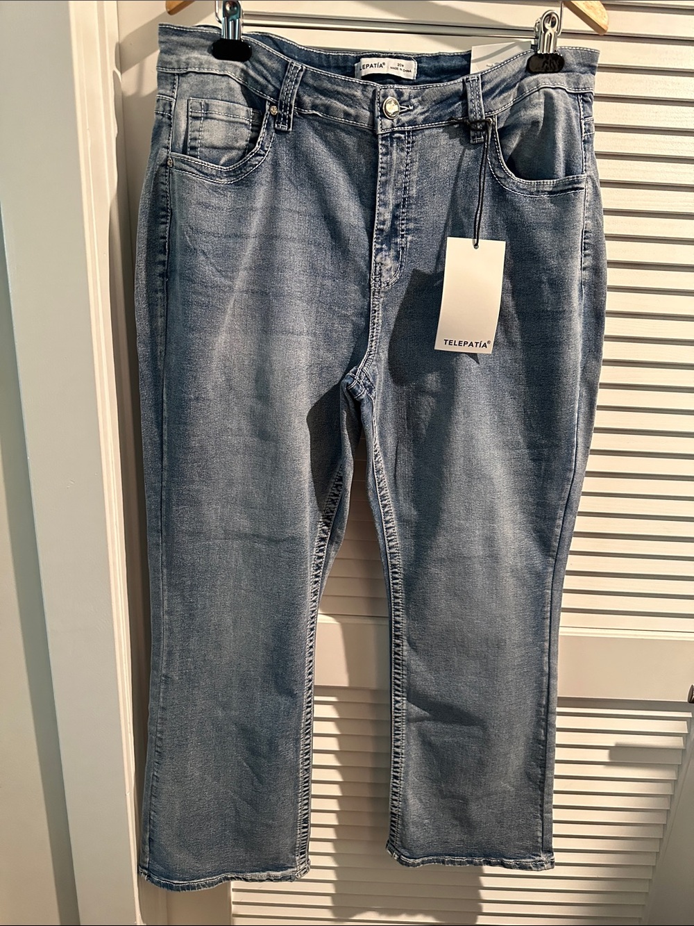 NWT Telepatia High Rise Bootcut Acid Wash Jeans with back pocket design.